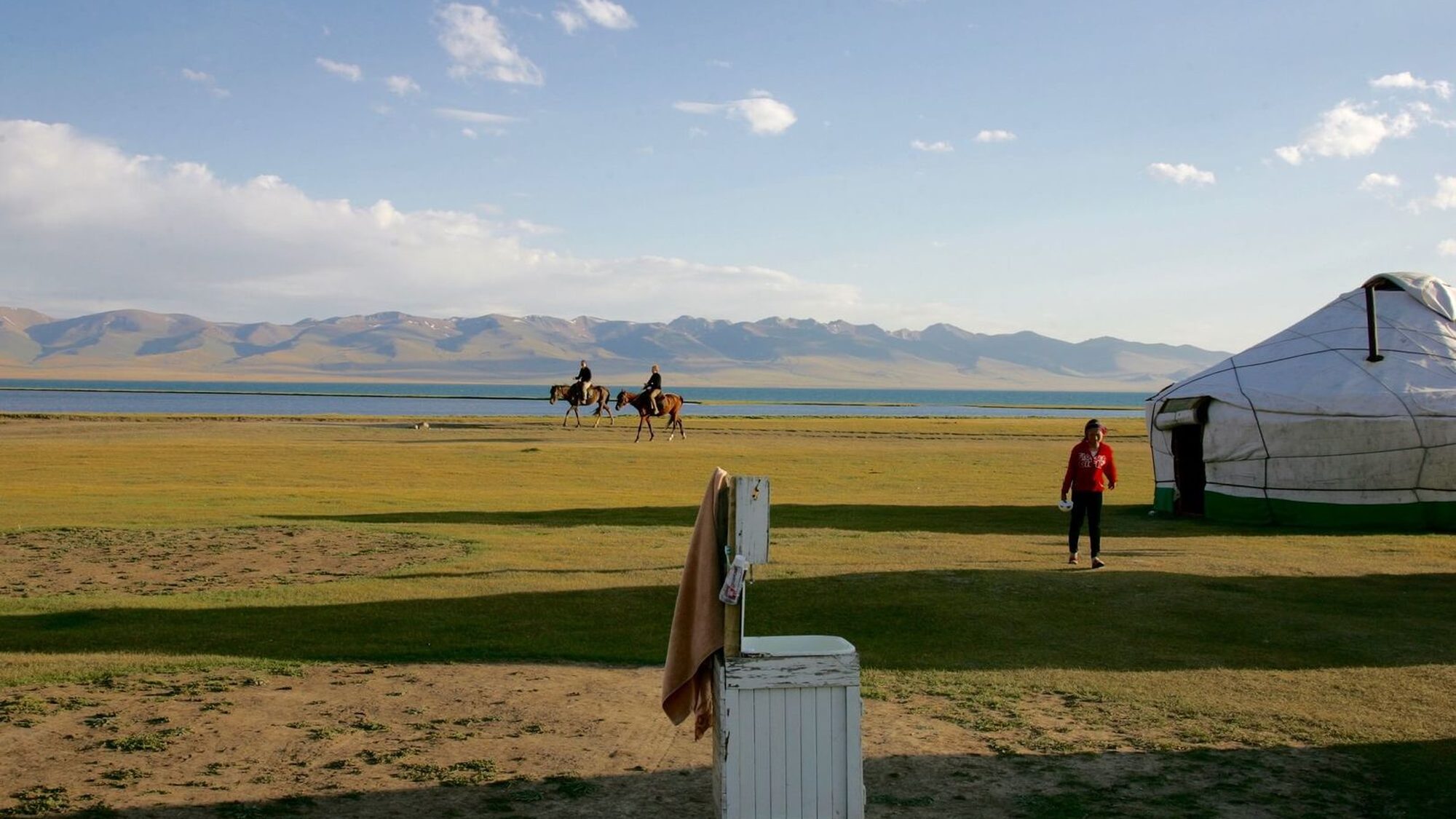 Yurts beside Song-Köl lake beneath the Tian Shan at golden hour